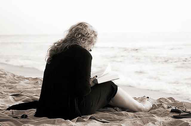 A book reviewer reading in an ocean side