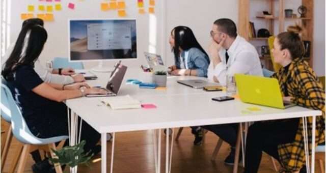 A team in an office discussing email monetization during a meeting